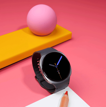 smartwatch displayed alongside a colored pencil and paper