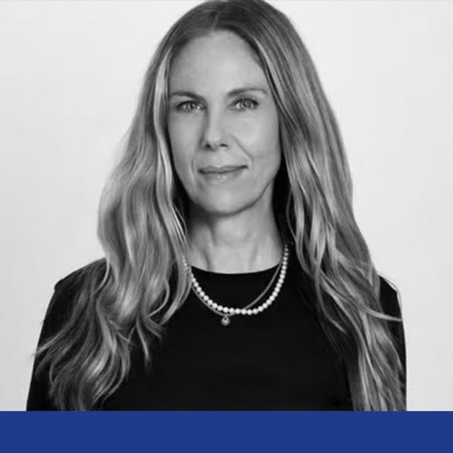 portrait with a woman wearing a black top and pearl necklace