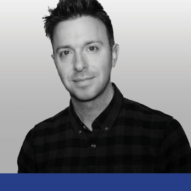 portrait of a person wearing a black and white checkered shirt against a neutral background