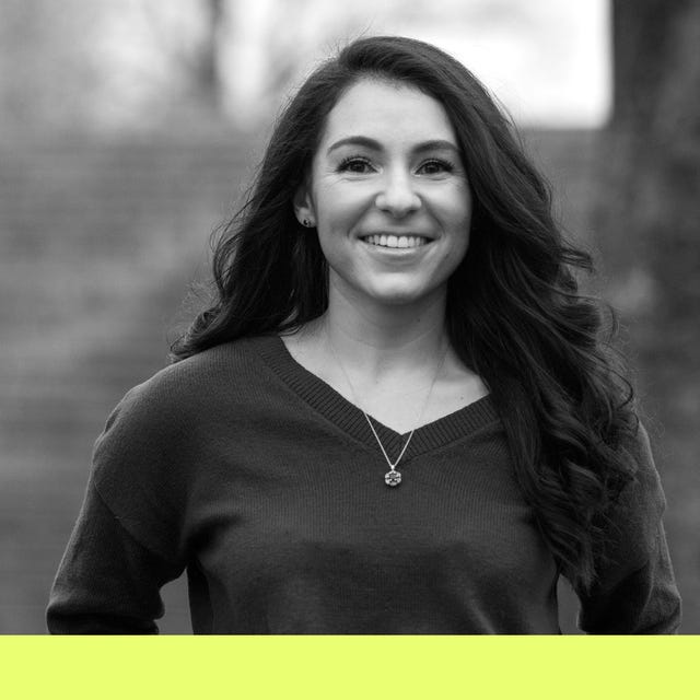 a person wearing a sweater and necklace with a blurred face for privacy