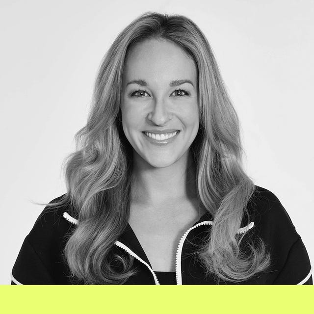 a woman with long wavy hair wearing a black zipup jacket