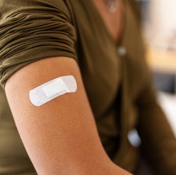 bandage on arm of a female after taking vaccine