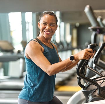 portrait of a young black woman exercising on an elliptical trainer in a gym, running using thereadmill machine equipment, healthy lifestyle and cardio exercise at fitness club concepts