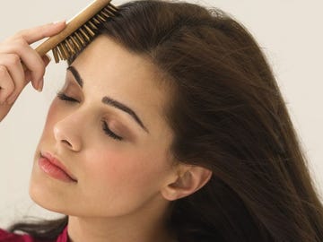 Close-up of a woman brushing her hair