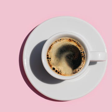 a shot of coffee on a pink background