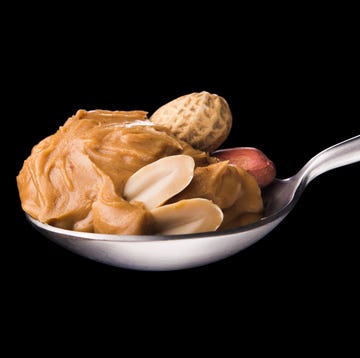 peanut butter on a spoon isolated on a black background