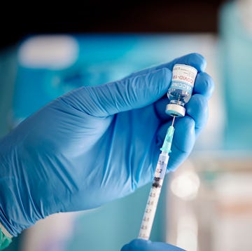 a healthcare worker prepares a dose of covid 19 vaccine
