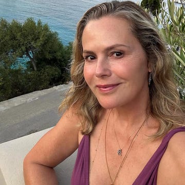 selfie with a coastal background featuring yachts and trees