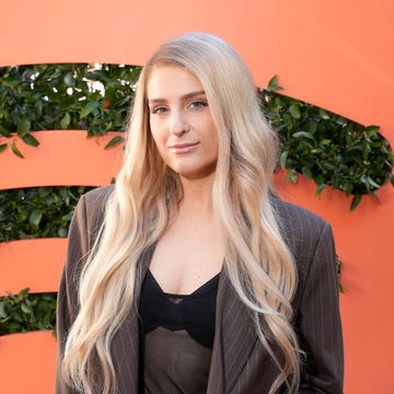 meghan trainor in front of the spotify logo