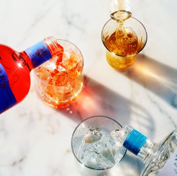 beverages being poured into glasses on a marble surface