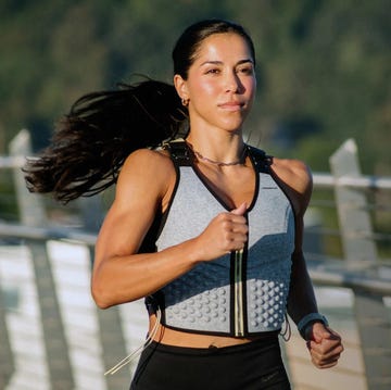 a woman wearing a weighted vest for walking benefits cardiovascular and muscular health by adding resistance and intensity to walking workouts