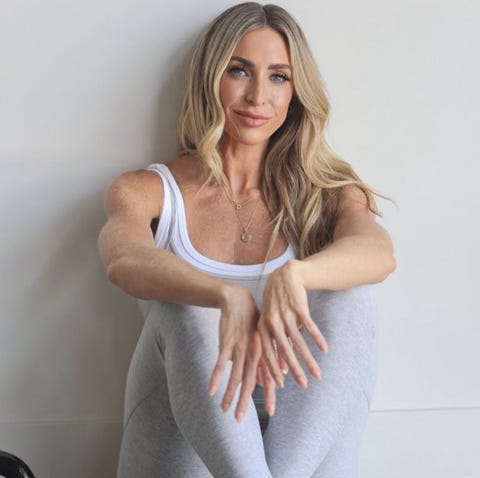 person seated with legs drawn up and hands resting on knees