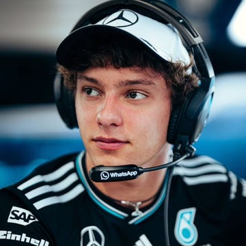 team member in a racing environment engaged in communication and analysis