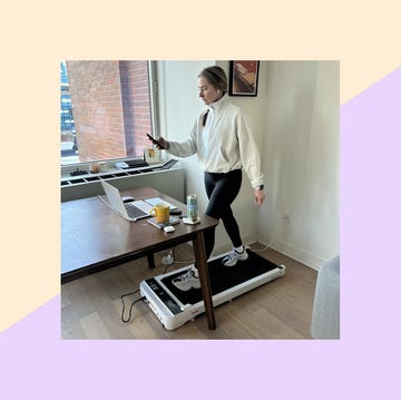 individual using a treadmill while working in a home office setting