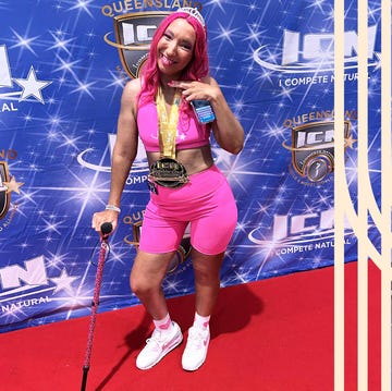 athlete posing with a medal at a competition