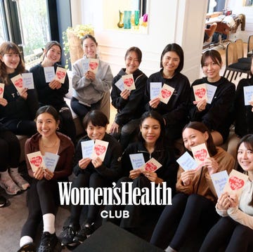 group of individuals holding promotional cards together