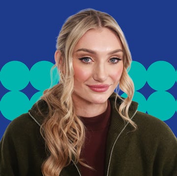 person with long wavy hair in front of a blue background with teal circles