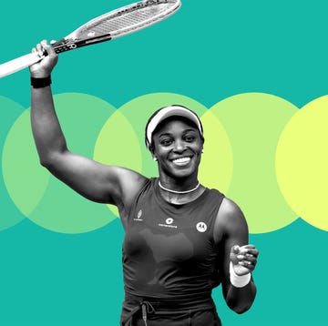 tennis player celebrating with a racket raised