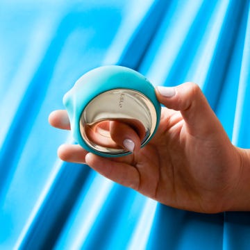 a tester holding the lelo ora 3 oral sex toy