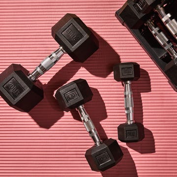 dumbbells of various weights on a textured surface