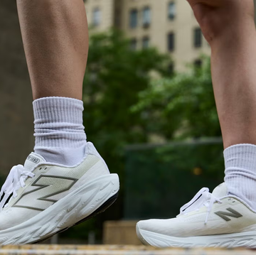 athletic shoes worn by a person standing in an urban environment