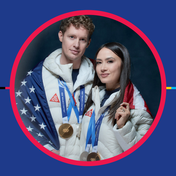 two individuals wearing medals and jackets celebrating a victory