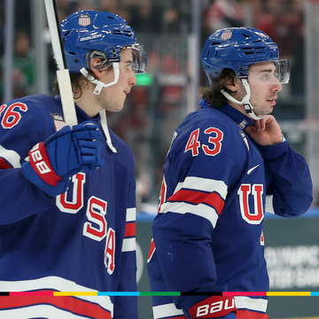 two ice hockey players in team usa uniforms during a game